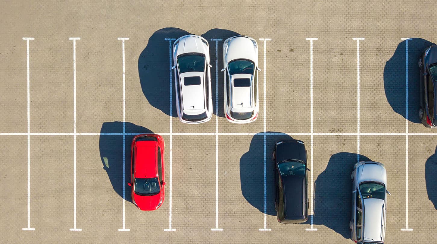 aerial-view-of-many-colorful-cars-parked-on-parkin-2022-01-04-20-02-34-utc.jpg